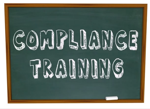 Compliance Training written in all caps on a chalkboard.